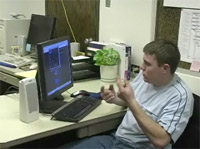 Photo of a student at a computer using sign language